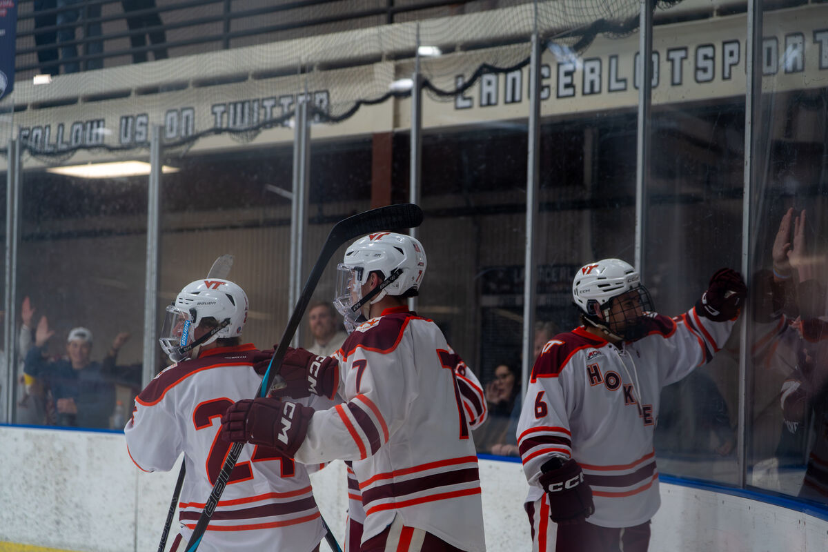 Virginia Tech hockey players gathered on the ice